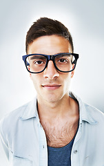 Image showing Portrait, serious and business man in glasses in studio isolated on a white background. Face of confident nerd, geek and professional entrepreneur, employee or worker, programmer or coder in Brazil