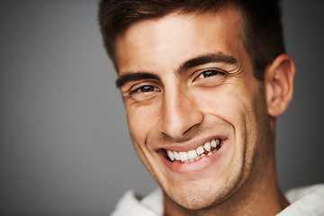 Image showing Portrait, smile of man and student in studio isolated on a gray background mockup space. Face, happy young person and model with positive facial expression, excited and cheerful in Spain at college