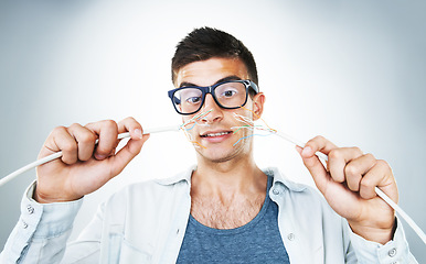 Image showing IT support, cable and power with an electrician man in studio on a gray background for troubleshooting. Face, hands and glasses with an engineering nerd or technician connecting wires for internet