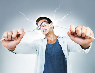 Image showing Man, holding and wire for power in studio for electric engineering mockup on gray background. Portrait, male model or technician for cable by fixing, repair and technology for glitch on web in Spain