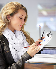 Image showing Artist, student or woman with paper, pencil or schedule in design school for exam, assignment or drawing. Smile, happy or person sketching creative brief, idea or planning color inspiration in studio