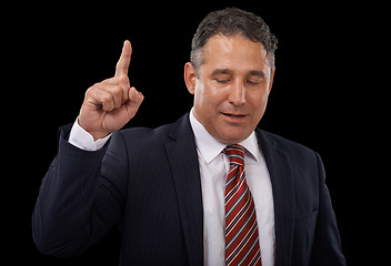 Image showing Pointing up, business and man with promotion, opportunity and lawyer on a dark studio background. Mature person, professional or entrepreneur with a decision, choice or announcement with mockup space