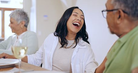 Image showing Happy, woman and laugh with family at dinner in home, living room and joke with grandparents. Senior man, talking and lady smile at comedy or conversation at celebration, event or lunch together