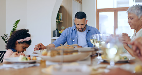 Image showing Christian, family and praying at dinner in home with gratitude, thanks and praise for God. People, pray and together giving spiritual respect or grace at lunch, table and holding hands in dining room