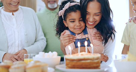 Image showing Child with birthday cake, candles and family to celebrate with smile, fun and love together in home. Happiness, gift and congratulations, mom and grandparents at kids party with excited children.