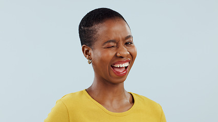 Image showing Portrait, black woman with smile and wink in studio for like, opportunity or deal agreement gesture. Flirt emoji, romantic offer and face of girl with confidence, pride and secret on white background