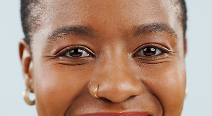 Image showing Happy, eyes and portrait of black woman on blue background for confidence, pride and beauty. Cosmetics, closeup and face of African person smile with happiness, makeup and dermatology in studio