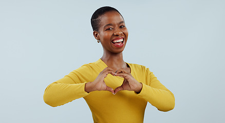 Image showing Happy black woman, portrait and heart hands for love, care or romance against a gray studio background. Face of African female person or model showing like emoji, shape or romantic gesture on mockup