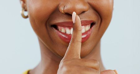 Image showing Black woman with secret, finger on mouth and smile for news, announcement or offer with gossip in studio. Whisper, silence or happy person with hand on lips for confidential info on white background