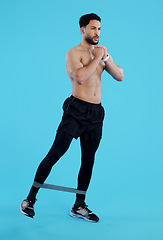 Image showing Man, legs and resistance band in workout, training or fitness against a blue studio background. Male person, athlete or serious model with straps for cardio exercise, endurance or stamina on mockup