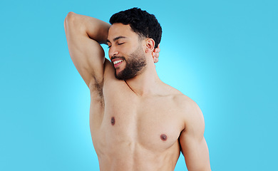 Image showing Happy man, armpit and smile for body hygiene, skincare or healthy wellness against a blue studio background. Male person or model in grooming, self care or fresh smell for clean skin on mockup space
