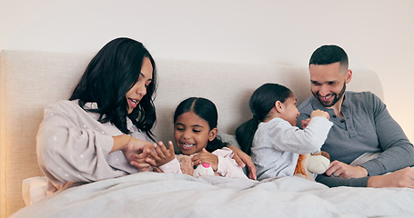 Image showing Family, home and parents with children in bed for bonding, sleeping together and conversation. Night, support and happy mother, father and kids in bedroom talking for love, care and relax on weekend