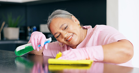 Image showing Cleaning, mature or woman by detergent on kitchen counter, housekeeper pride or smile for home hygiene. Happy, person and hand for housekeeping to shine, sanitizer and disinfectant surface in house