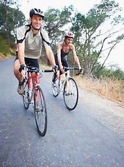 Image showing Happy couple, cycling and road in nature for, fitness, training or travel on bicycle together. Outdoor, people and exercise on bike for fun, workout and path in countryside for adventure or journey