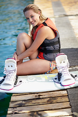 Image showing Woman, happy or wakeboard portrait by water, lake or ocean sea with fitness hobby, workout or safety gear. Person, life jacket or athlete with swimsuit, exercise or sports training equipment on break