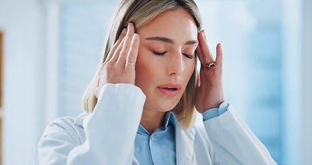 Image showing Doctor, woman and headache in office with burnout, stress and risk at hospital or clinic from migraine. Person, employee or professional with wellness, anxiety or discomfort from strain at workplace