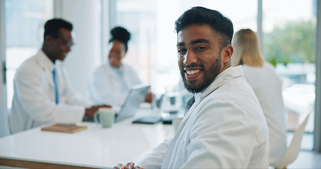 Image showing Portrait, man and doctors in a meeting, smile and healthcare with planning, talking and teamwork. Face, professional and group with management staff, research and brainstorming with conversation