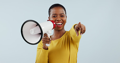 Image showing Happy black woman, portrait and pointing to you with megaphone for choice against a gray studio background. African female person smile with loudspeaker or bullhorn for selection, choosing or sale