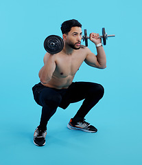 Image showing Man, fitness and squat with dumbbells for weightlifting, bodybuilding against a blue studio background. Male person or bodybuilder lifting weights for strength workout, exercise or training on mockup