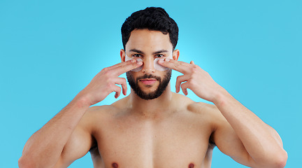 Image showing Skincare, portrait and man with eye patches for anti ageing treatment isolated on blue background. Care, skin and face of model with collagen mask on eyes, dermatology and luxury spa facial in studio