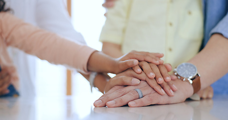 Image showing Family, hands together and holding with closeup in home for trust, support and care. Man, woman and kids with pile for unity, community or collaboration on table in kitchen with generation for future