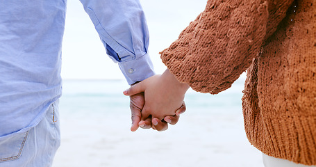 Image showing Couple, holding hands and beach for love, care or support in trust, travel or outdoor getaway together. Closeup of man and woman touching in romance for unity, bonding or compassion on ocean coast