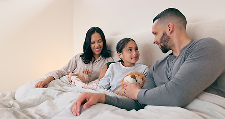 Image showing Home, bed and family with parents, girls and toys with happiness, morning and weekend break. Bedroom, mother and father with kids, playing and bonding together with love, relax and peace with fun