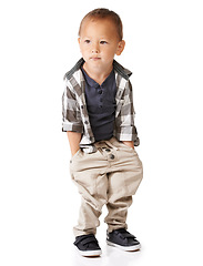 Image showing Fashion, children and a trendy boy in studio isolated on a white background for youth style. Kids, style and a cool young model in a casual clothing outfit with hands in his pockets to relax