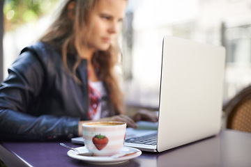 Image showing College student, working and laptop outdoor at coffee shop, cafe or restaurant with espresso, latte or cup. Girl, studying and drink a green tea or beverage in summer, morning or bistro on campus