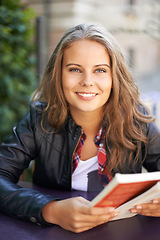 Image showing College student, portrait and reading a book at cafe on university, campus or restaurant. Happy, woman and learning from studying books, textbook or relax with knowledge at outdoor coffee shop