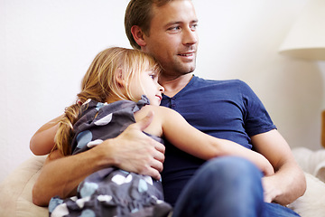 Image showing Father, girl and hug with smile, couch and embrace with love, daughter and house. Man, happy and lounge or bonding together for affection, family and parent with child, caring and family home