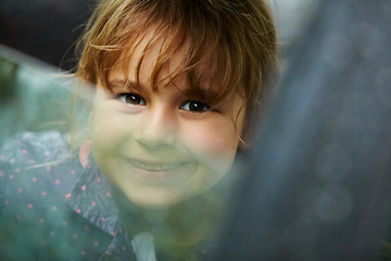 Image showing Portrait, smile and a girl in a car for a road trip to travel as a passenger on holiday or vacation. Kids, face and a happy young girl child in a vehicle to drive for transport closeup on the weekend