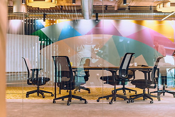 Image showing In the contemporary setting of an empty modern glass startup office, the space exudes a sleek and innovative atmosphere, ready to be filled with the potential of entrepreneurial endeavors