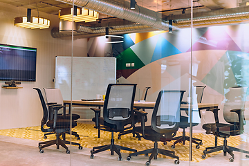 Image showing In the contemporary setting of an empty modern glass startup office, the space exudes a sleek and innovative atmosphere, ready to be filled with the potential of entrepreneurial endeavors