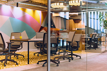 Image showing In the contemporary setting of an empty modern glass startup office, the space exudes a sleek and innovative atmosphere, ready to be filled with the potential of entrepreneurial endeavors