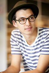Image showing Fashion, thinking and a young hipster man in a glasses for vision or eyesight on a blurred background. Style idea, eyewear and a confident person in a hat as a casual clothing outfit accessory