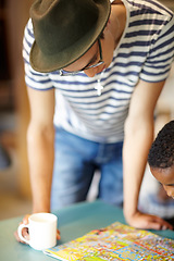 Image showing Teacher, reading and book in kindergarten for learning creative, art and support in education. Teaching, kid and studying or search picture on table for fun activity and development in classroom