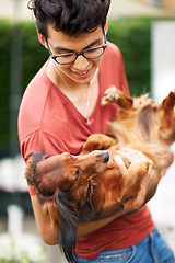 Image showing Man, dog or playing in garden of home for bonding, love and relationship for happiness or joy. Person, pet or holding animal in backyard, outdoor or nature for care, friendship or companion and smile