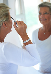 Image showing Senior woman, mascara and mirror in home with smile, thinking and beauty to start morning in retirement. Elderly person, makeup and brush for eyelash, reflection and happy in bathroom for cosmetics