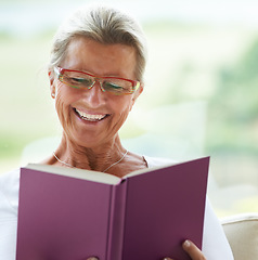 Image showing Happy senior woman, home and book with reading, sofa and relax in living room with story, knowledge and glasses. Elderly lady, person and thinking on lounge couch in retirement with novel in house