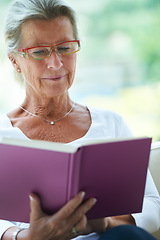 Image showing Senior woman, book and reading in house, sofa and relax in living room with story, knowledge and glasses. Elderly lady, person and thinking on lounge couch in retirement with novel in nursing home