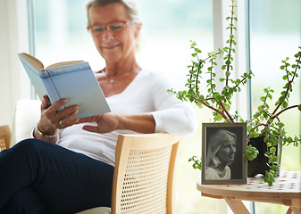 Image showing Senior, woman and relaxing with book in home for reading, wellness or self care. Elderly person, glasses and smile with happiness for resting, peace or retirement with vintage photograph for memory