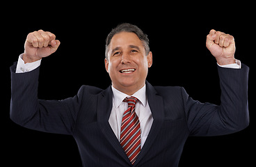 Image showing Business man, winner and power or yes for success, celebration and winning, achievement or goals in studio. Professional boss or mature person in suit with fist for motivation on a black background