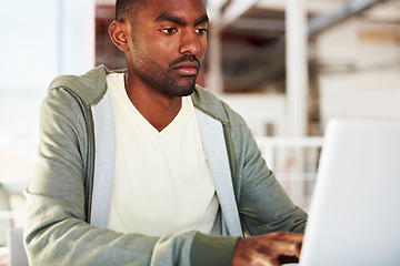 Image showing Serious, laptop and man in office for research, planning or schedule, freelance or analysis. Typing, face and African male manager online with social media, project management or email communication