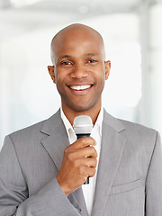 Image showing African man, microphone and portrait with smile, speaking and working at event, happy and employee. Speech, career and workplace for corporate seminar, speaker and hosting for business conference