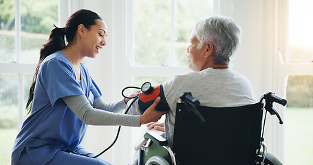 Image showing Woman, caregiver and senior in wheelchair for blood pressure, monitoring or elderly care at old age home. Nurse or medical doctor checking BPM of mature patient or person with a disability at house