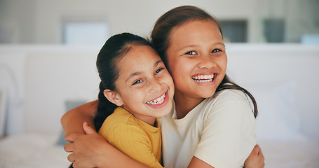 Image showing Siblings, portrait and sisters hug in home with love, care and kids with support on sofa in living room. Happy, face and children bonding in embrace together on couch in lounge of apartment or house
