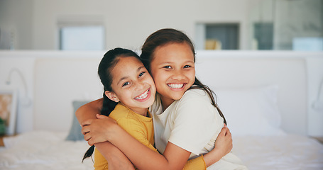 Image showing Sisters, portrait and siblings hug in home with love, care and kids with support on sofa in living room. Happy, face and children bonding in embrace together on couch in lounge of apartment or house