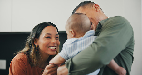 Image showing Family, smile and play or care, love and bonding in kitchen, relax and support or laughing at home. Happy parents and baby, connect and hug or embrace, fun and humor or conversation, silly and talk