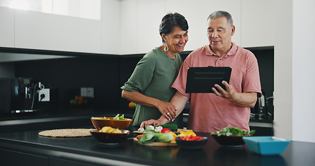 Image showing Senior couple, tablet and recipe for meal, kitchen and cooking together for bonding, smile and support. Happy elderly people, healthy food and diet in retirement, fun and app for meal prep or web
